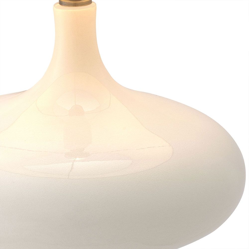 Beautiful table lamp with sweeping curves and natural linen shade with subtle embroidery