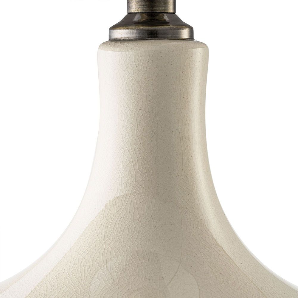 Beautiful table lamp with sweeping curves and natural linen shade with subtle embroidery