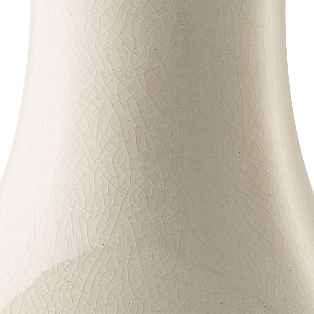 Beautiful table lamp with sweeping curves and natural linen shade with subtle embroidery