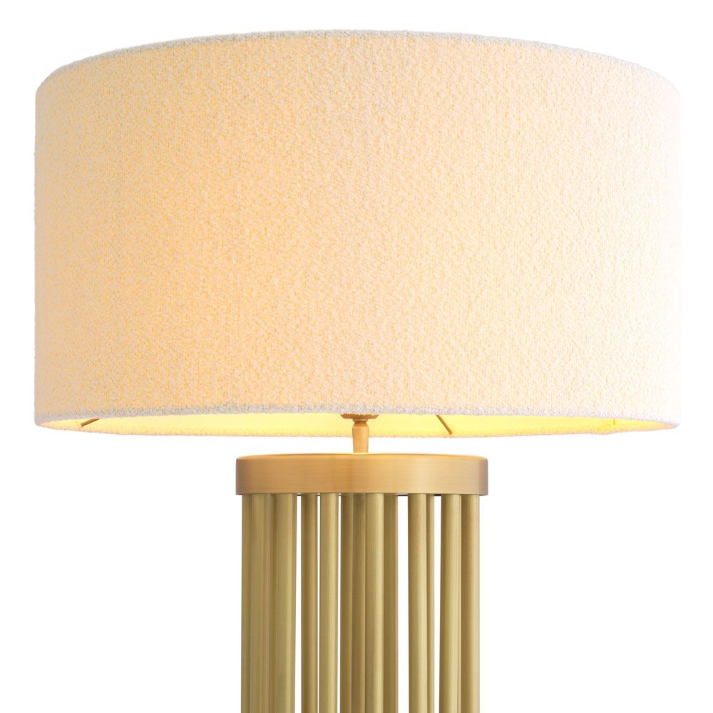 A stylish floor lamp by Eichholtz with a marble base, antique brass structure and finished with a contemporary boucle shade
