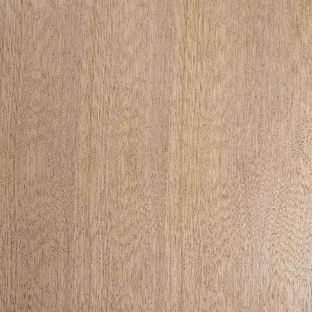A natural oak veneer dining table by Eichholtz featuring subtle asymmetrical table legs