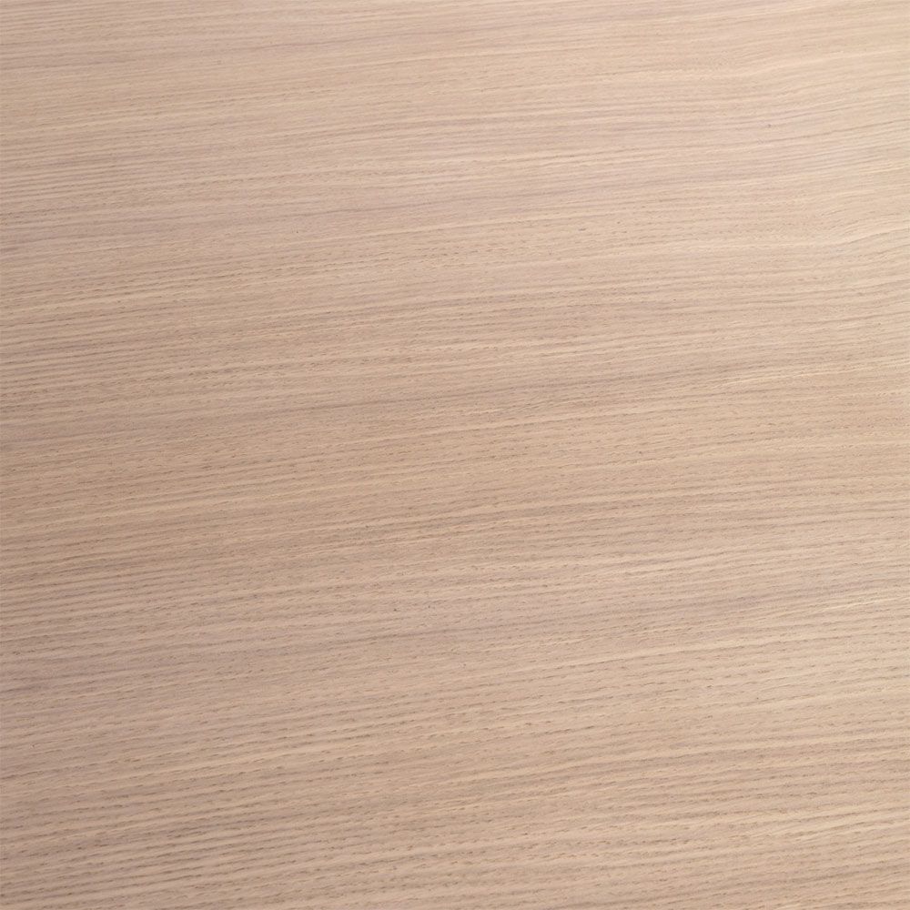 A rounded dining table by Eichholtz with a natural finish