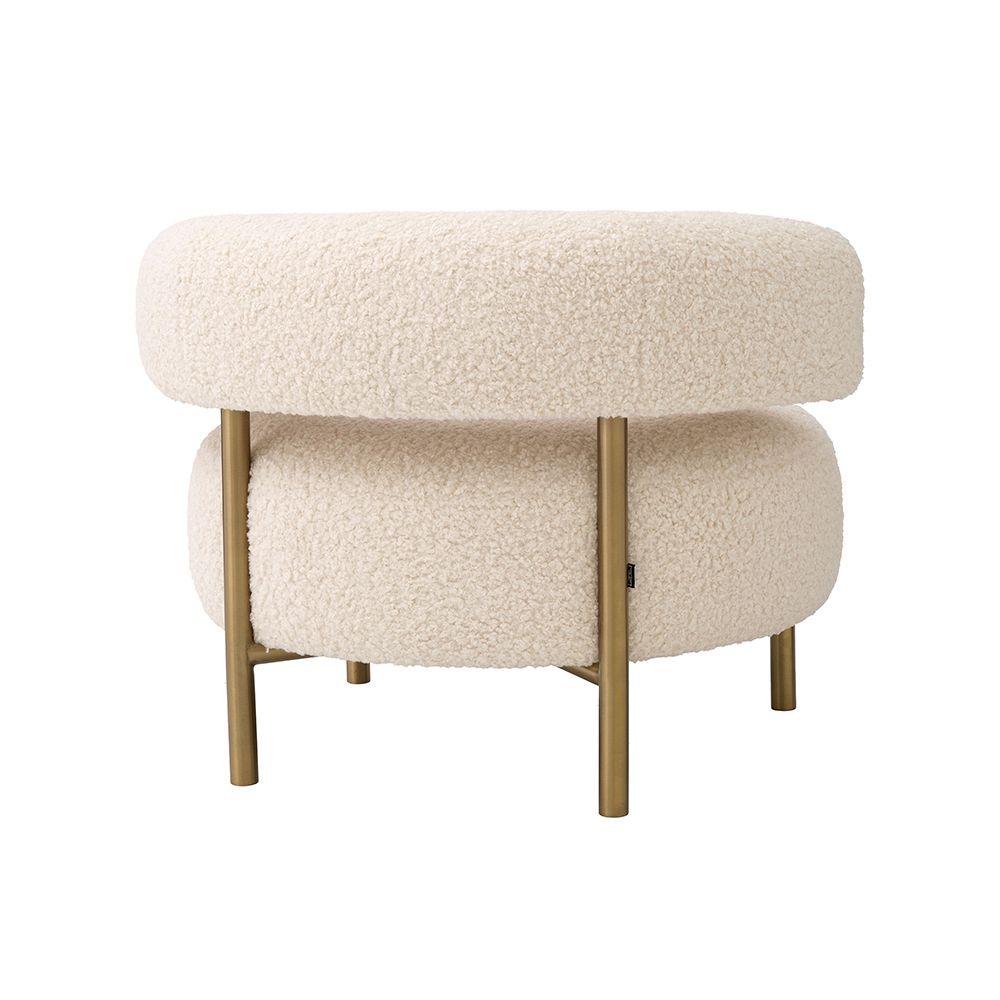 A glamorous chair by Eichholtz with a luxury upholstery and brushed brass legs 