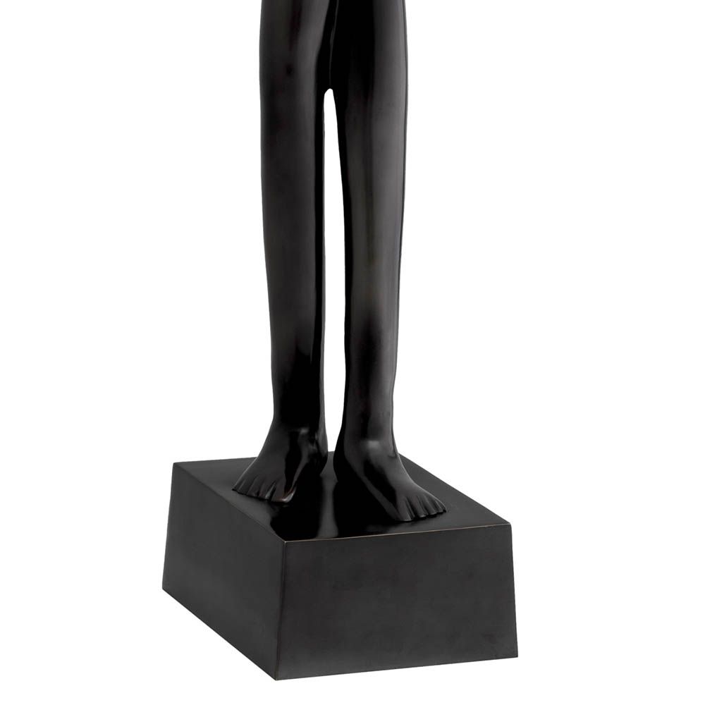 Tall headless figure in bronze finish