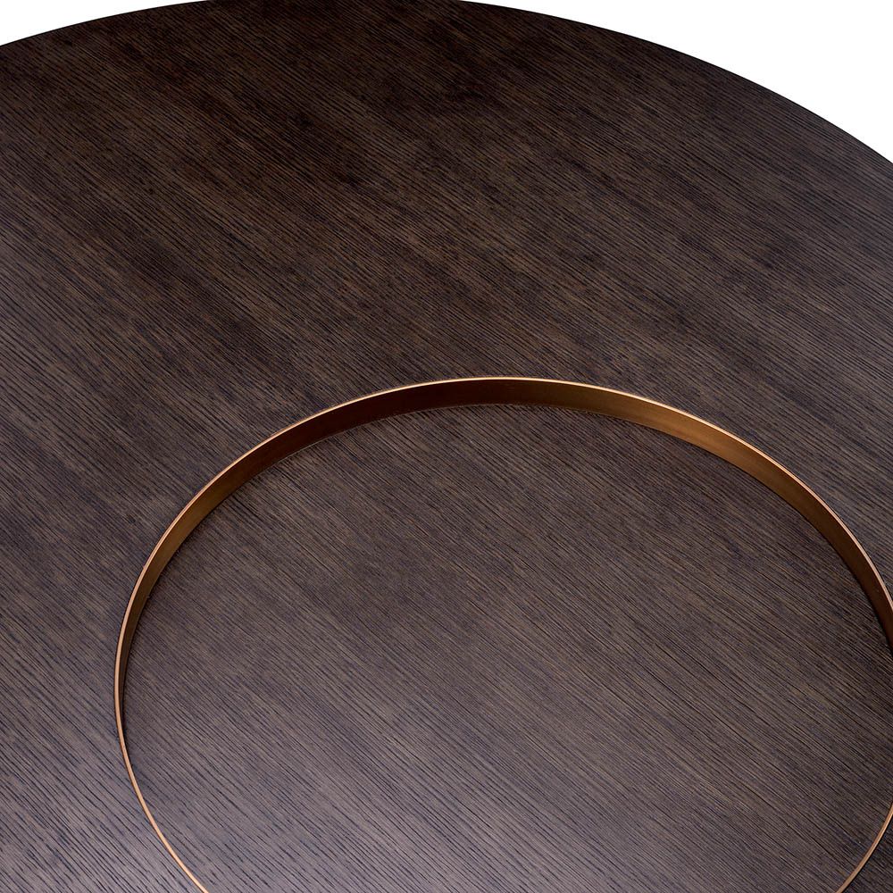 Round coffee table with dark wood top, sunken circular detail and gold accents