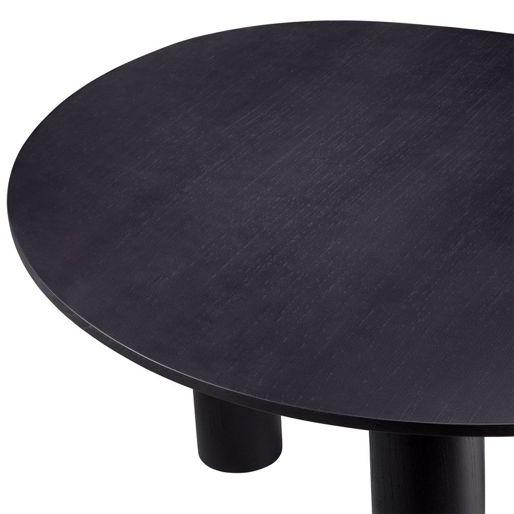 A luxurious black dining table by Eichholtz with a rounded table top 