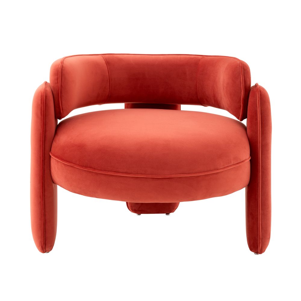 A contemporary armchair with a retro design, luxury velvet upholstery and sophisticated piping