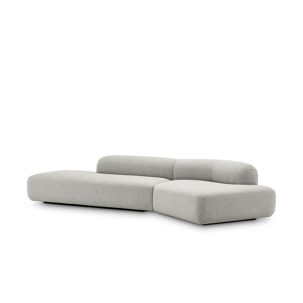 Stylish curved sofa upholstered in sleek grey upholstery