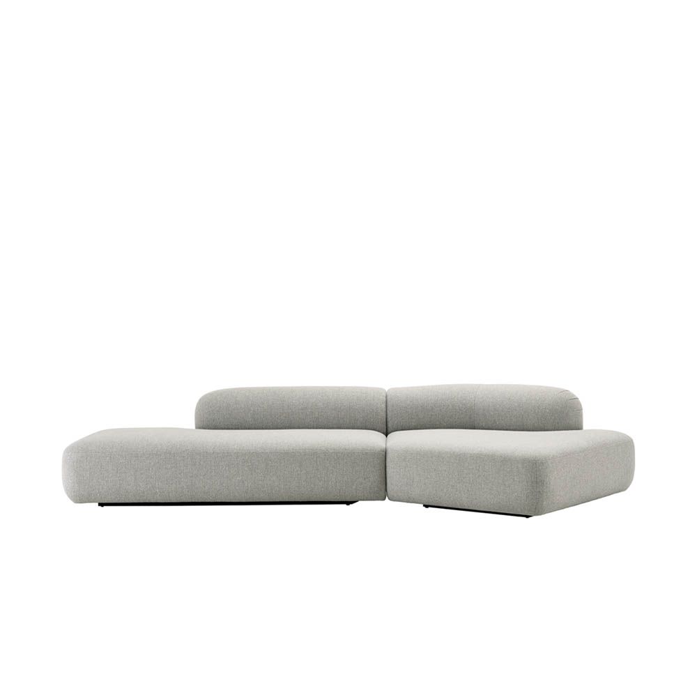 Stylish curved sofa upholstered in sleek grey upholstery