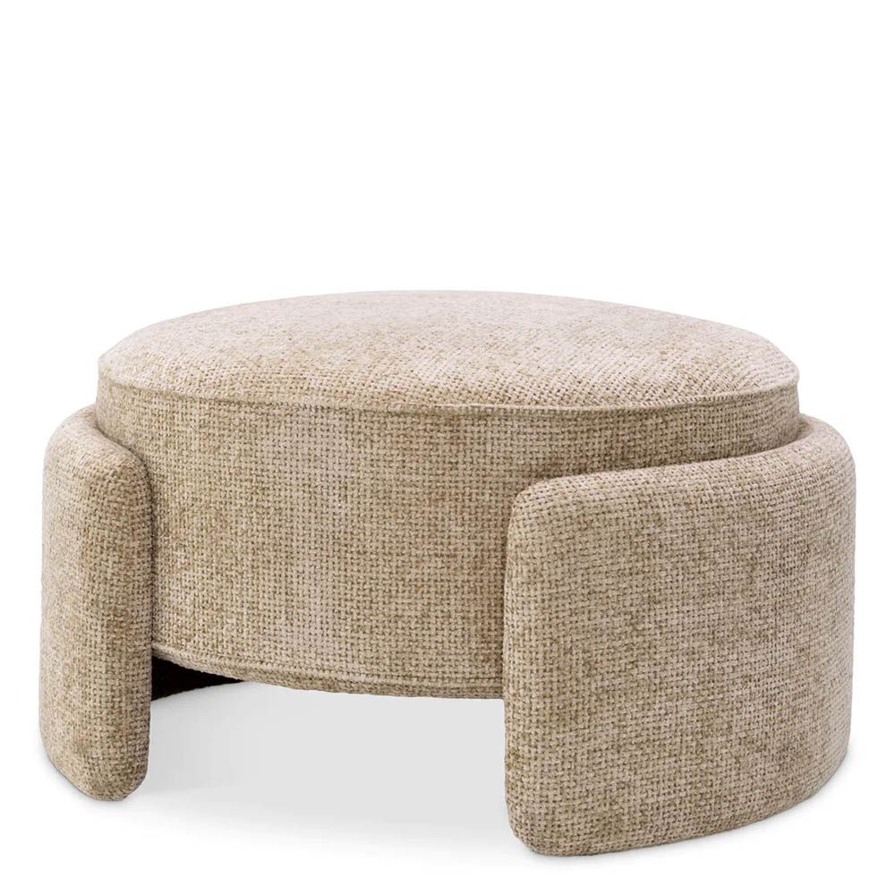 Round ottoman in lyssa sand upholstery with wrap around legs
