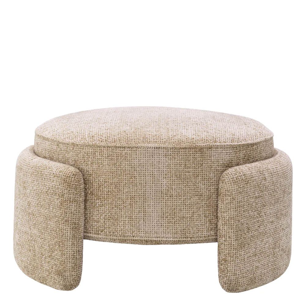 Round ottoman in lyssa sand upholstery with wrap around legs