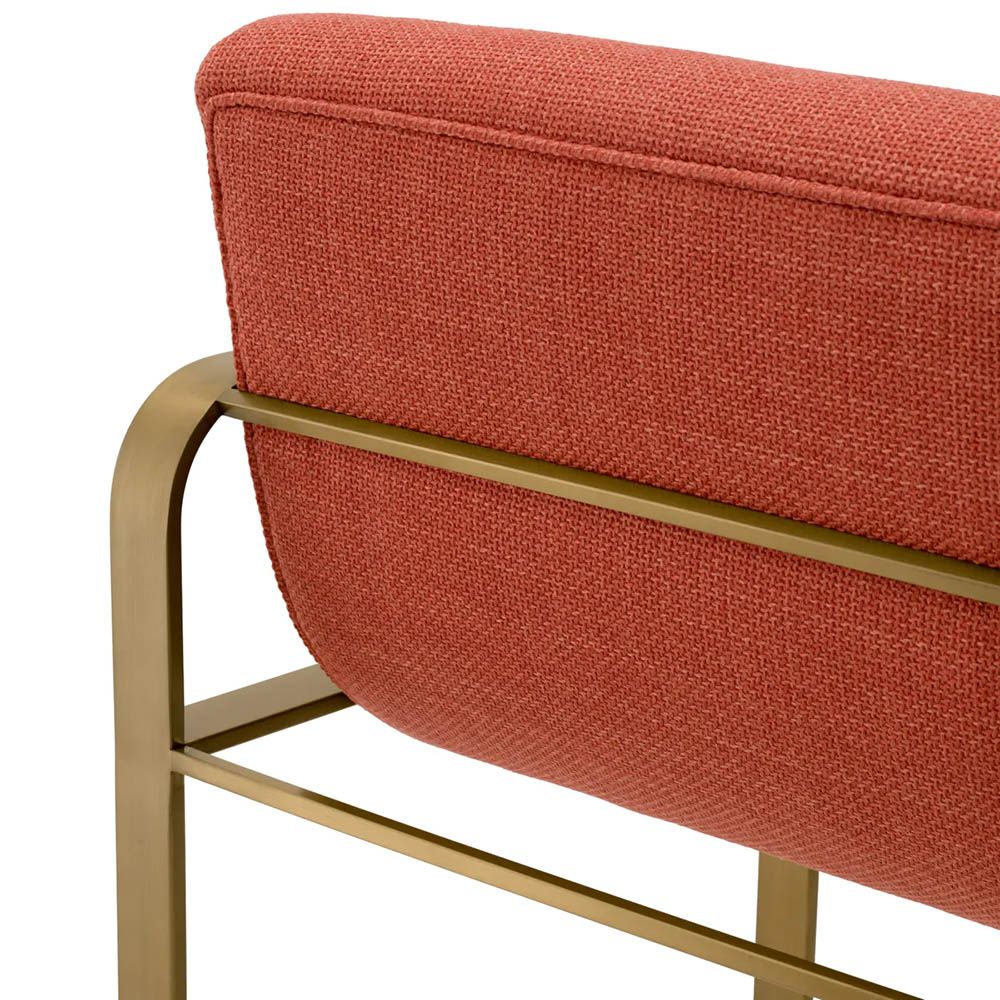 orange linen upholstered barstool with horizontal fluting and brass frame
