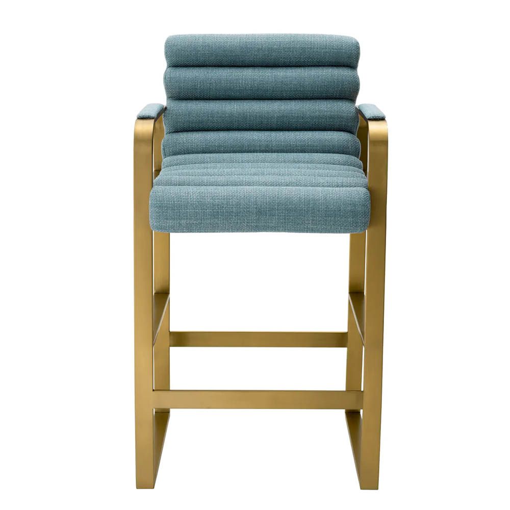 blue linen upholstered counter stool with horizontal fluting and brass frame