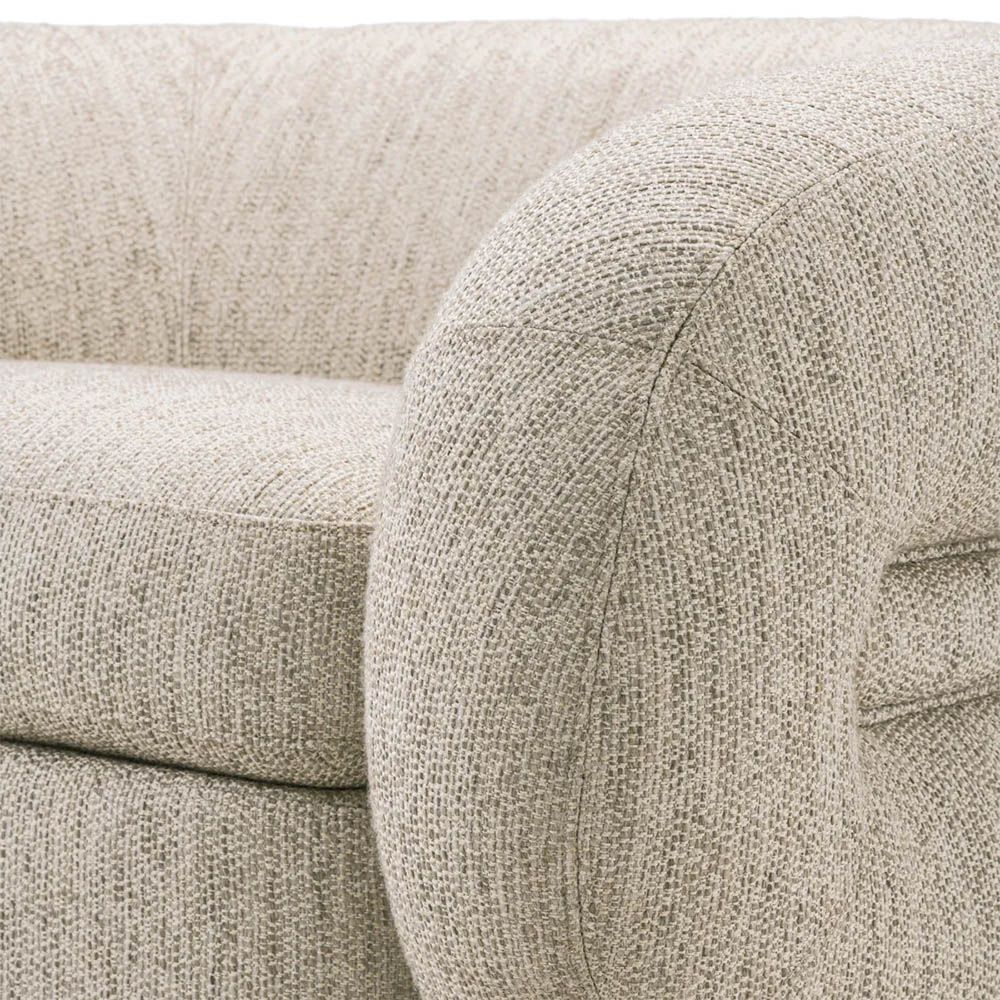 A luxury chair by Eichholtz with a gorgeous grey upholstery and brass plinth