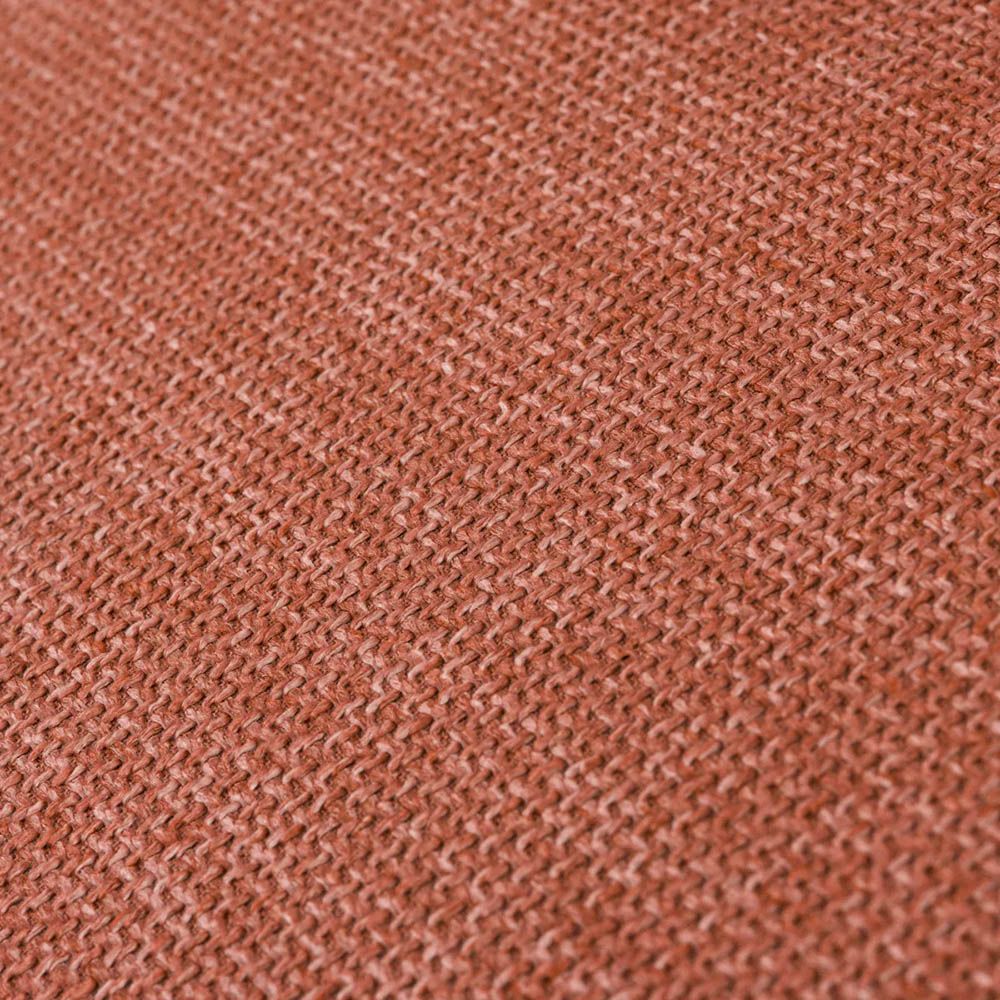 orange linen upholstered armchair with horizontal fluting and brass frame