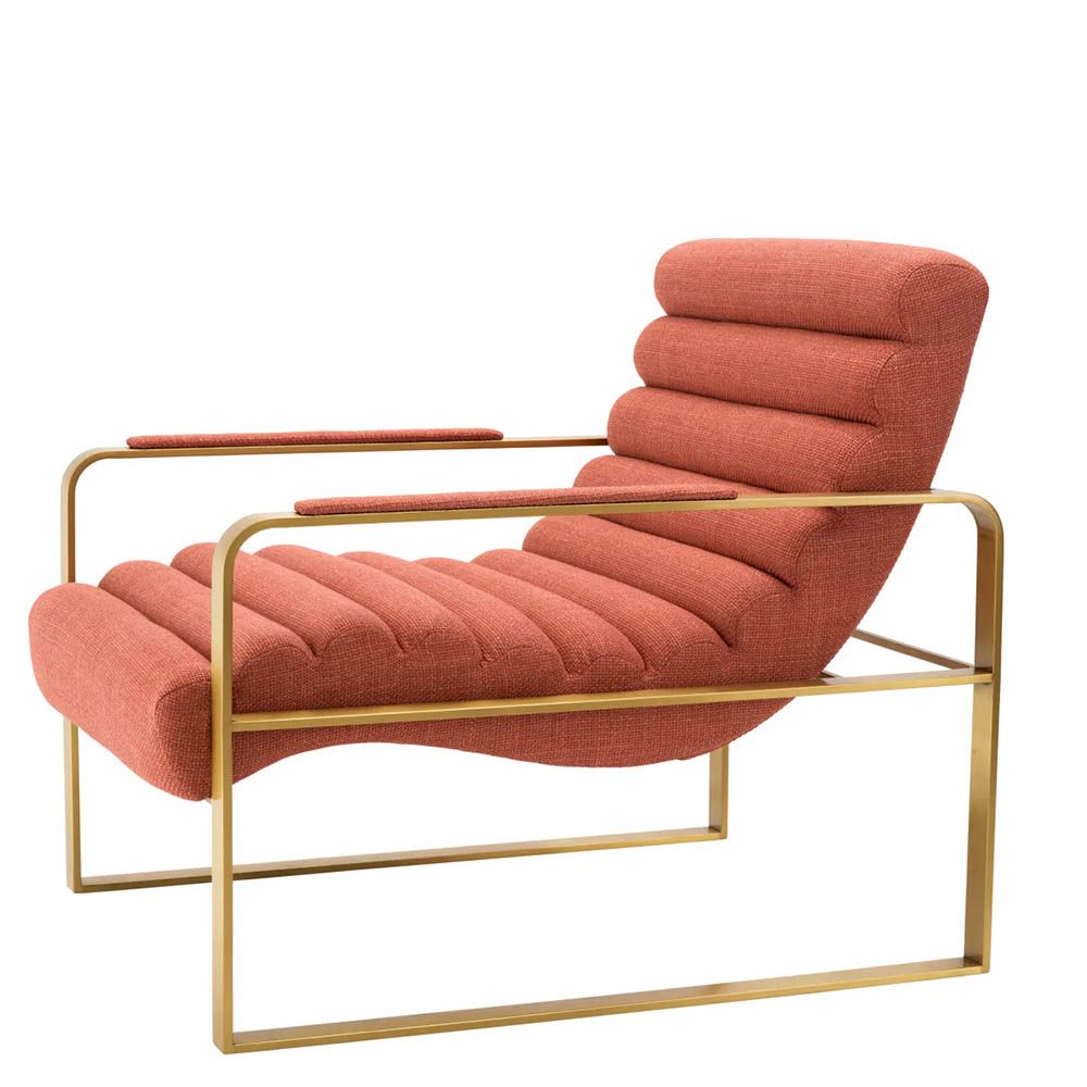 orange linen upholstered armchair with horizontal fluting and brass frame