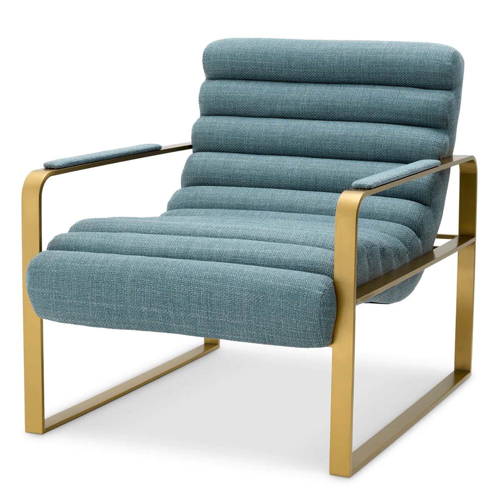 blue linen upholstered armchair with horizontal fluting and brass frame