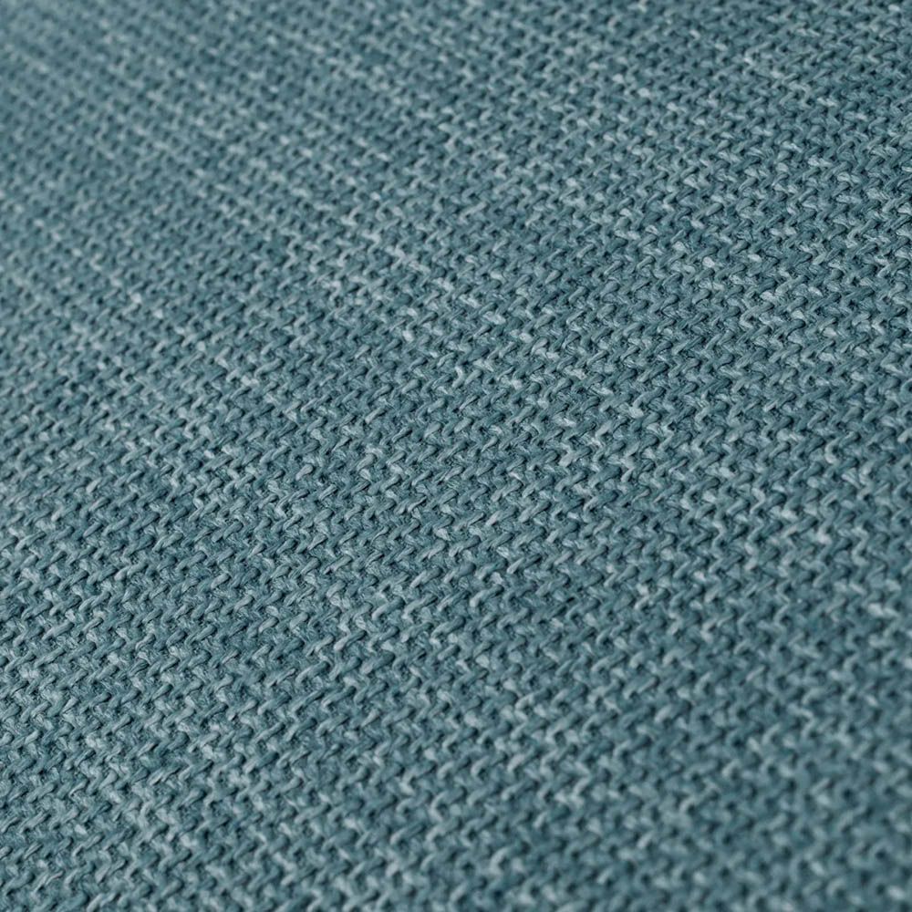 blue linen upholstered armchair with horizontal fluting and brass frame