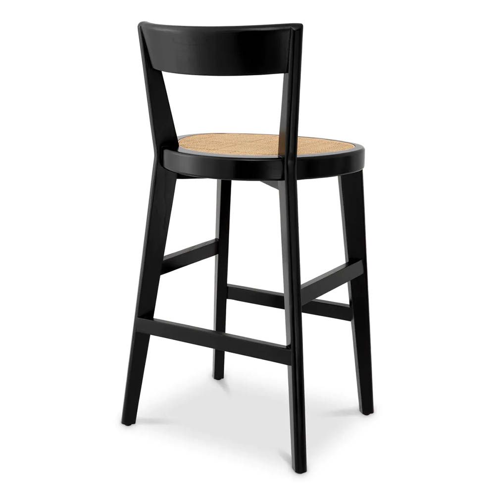A stylish barstool by Eichholtz with a black composition and rattan seat