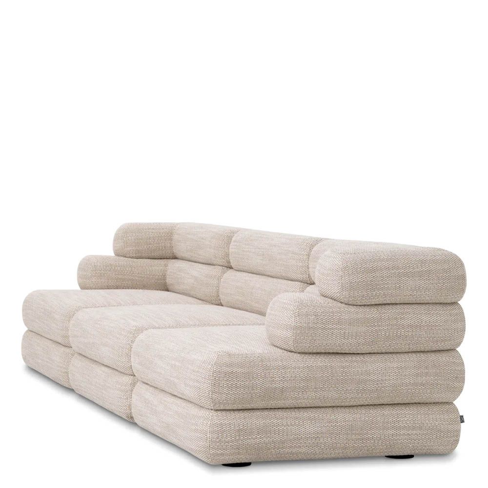 A contemporary modular sofa by Eichholtz with a sand coloured upholstery and modern design
