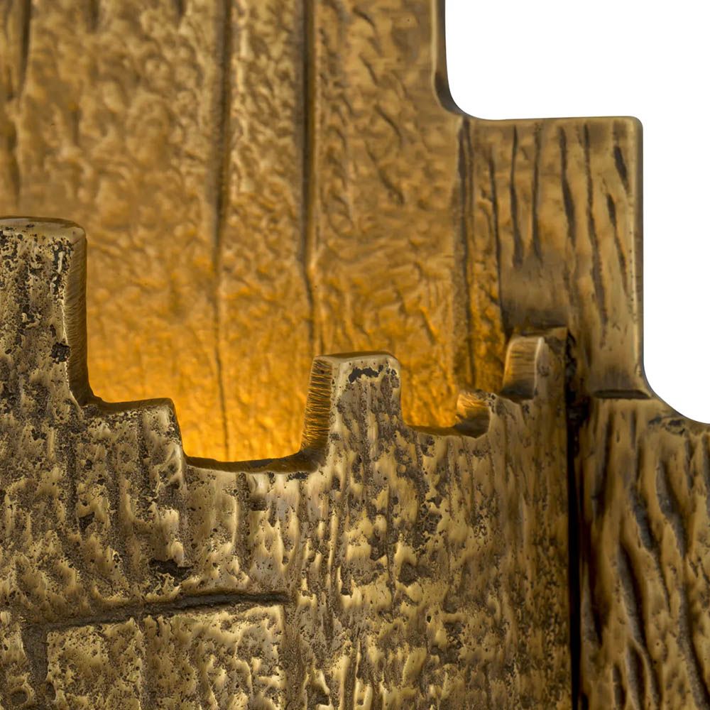 Brass finish wall lamp with textured edges and surface