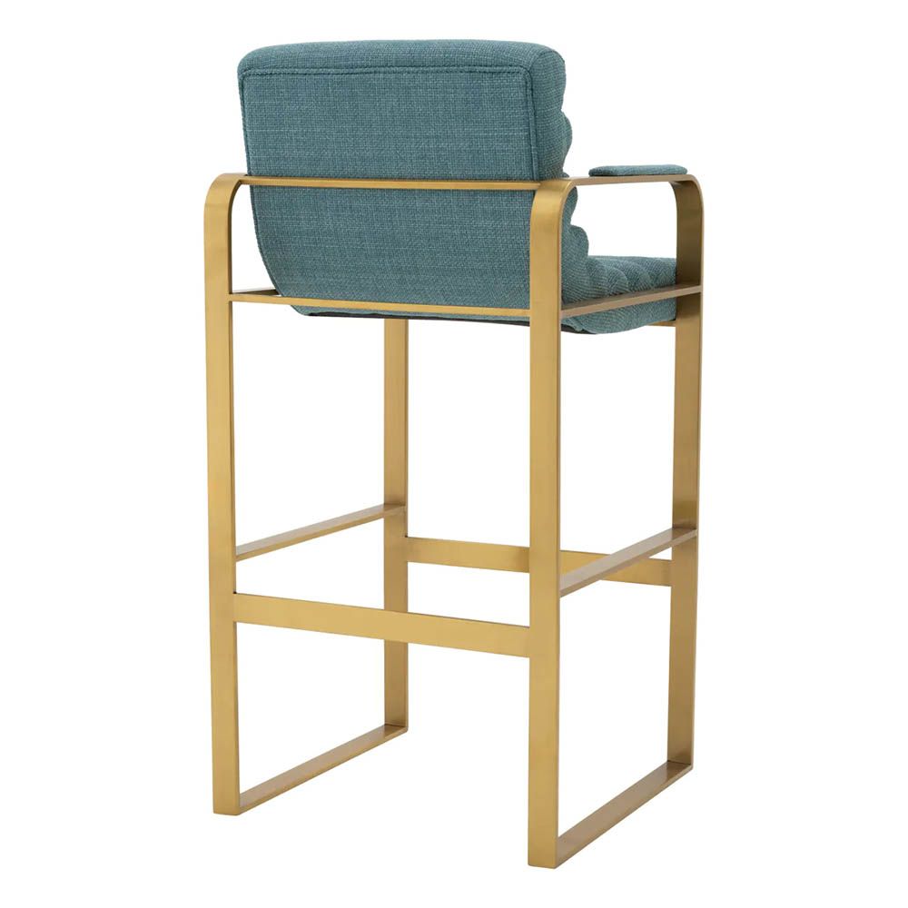blue linen upholstered bar stools with horizontal fluting and brass frame