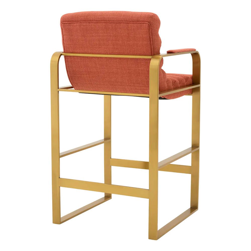orange linen upholstered counter stool with horizontal fluting and brass frame