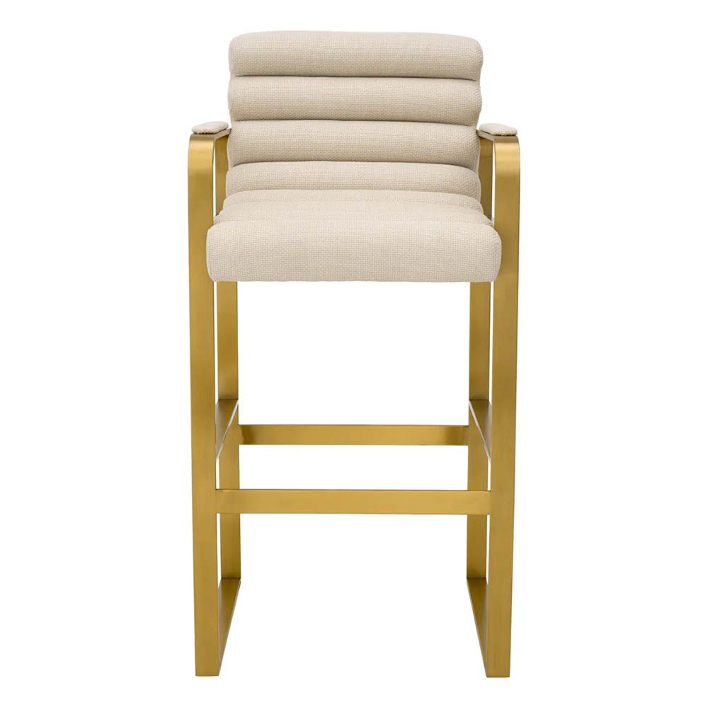 Cream linen upholstered bar stool with horizontal fluting and brass frame