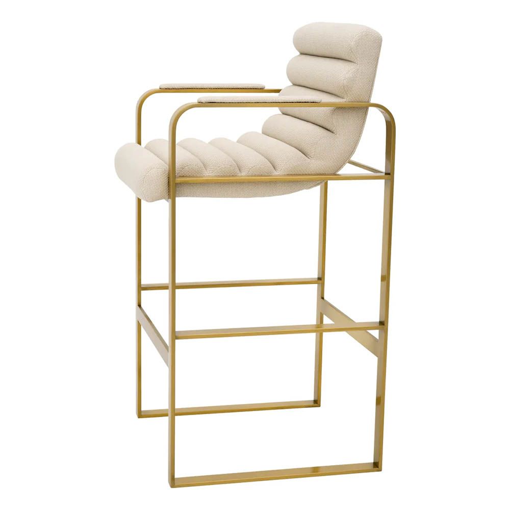 Cream linen upholstered bar stool with horizontal fluting and brass frame