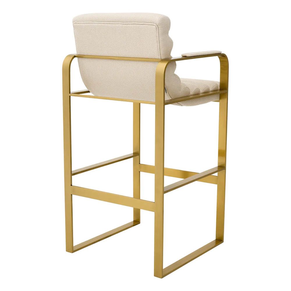 Cream linen upholstered bar stool with horizontal fluting and brass frame