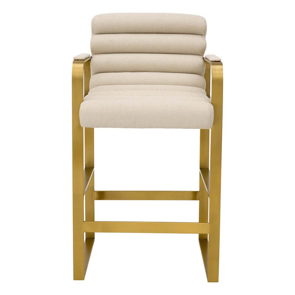 cream linen upholstered counter stool with horizontal fluting and brass frame