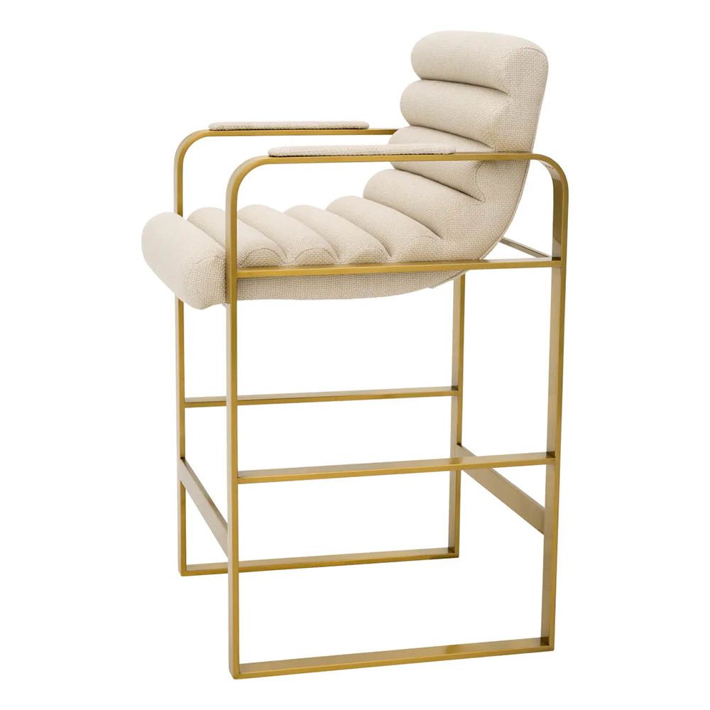 cream linen upholstered counter stool with horizontal fluting and brass frame