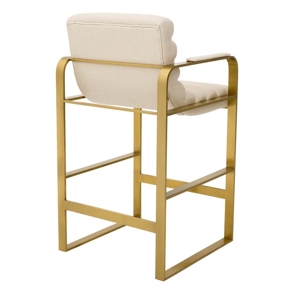cream linen upholstered counter stool with horizontal fluting and brass frame