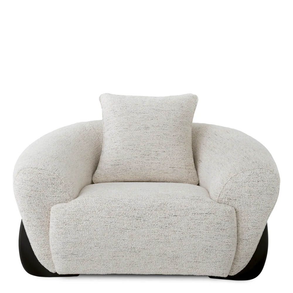 A luxury chair by Eichholtz with a grey upholstery and black wooden legs