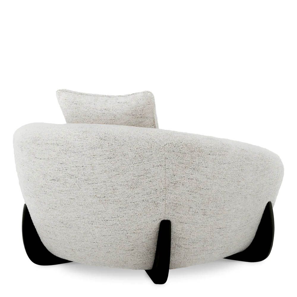 A luxury chair by Eichholtz with a grey upholstery and black wooden legs
