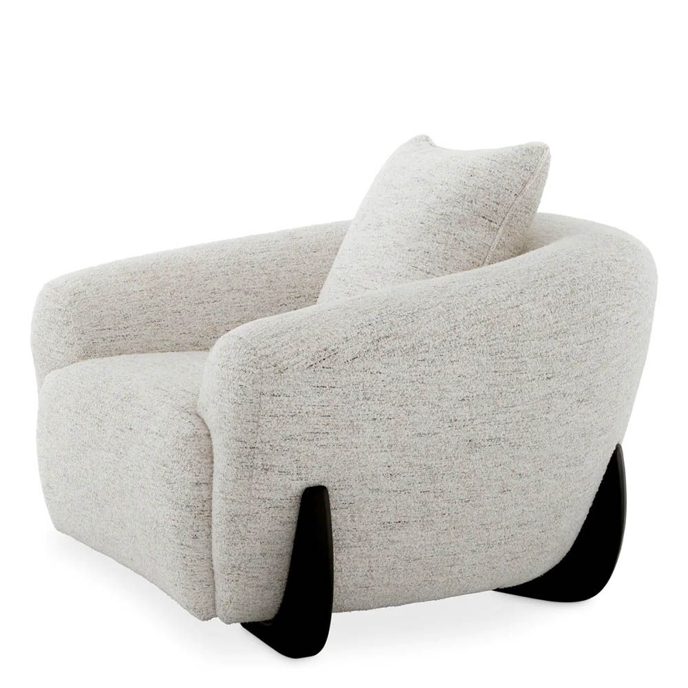 A luxury chair by Eichholtz with a grey upholstery and black wooden legs