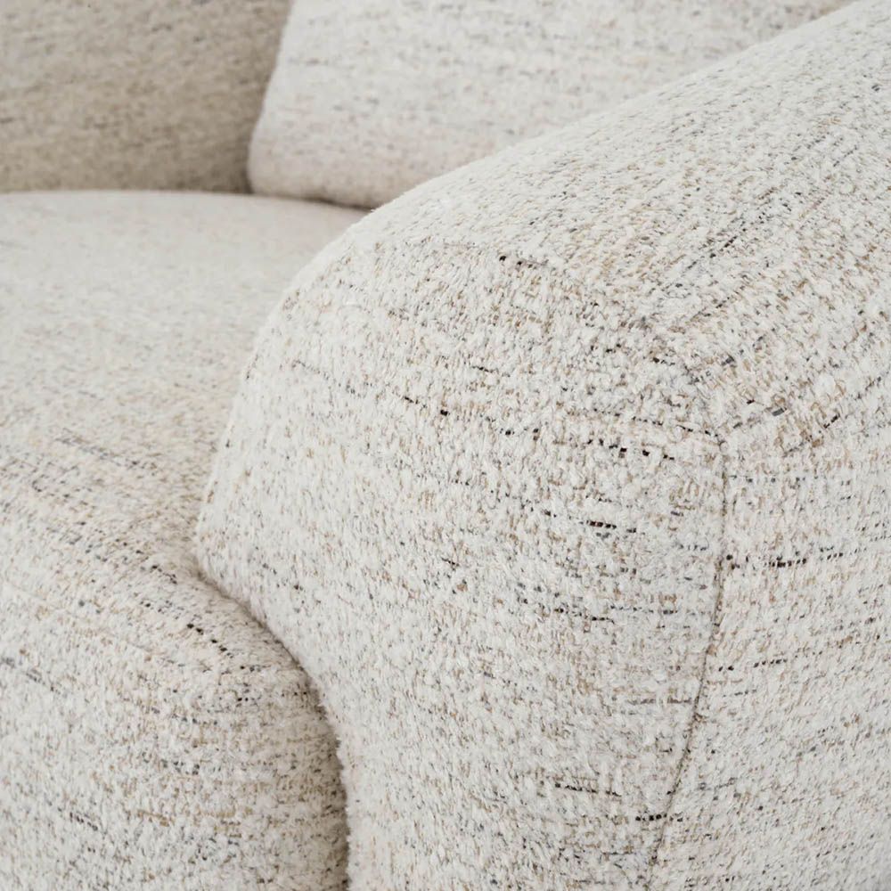 A luxury chair by Eichholtz with a grey upholstery and black wooden legs