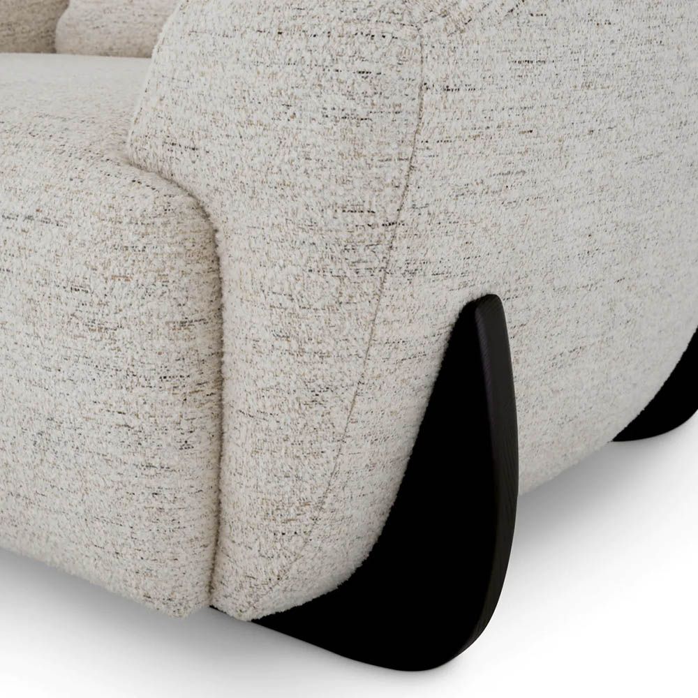 A luxury chair by Eichholtz with a grey upholstery and black wooden legs