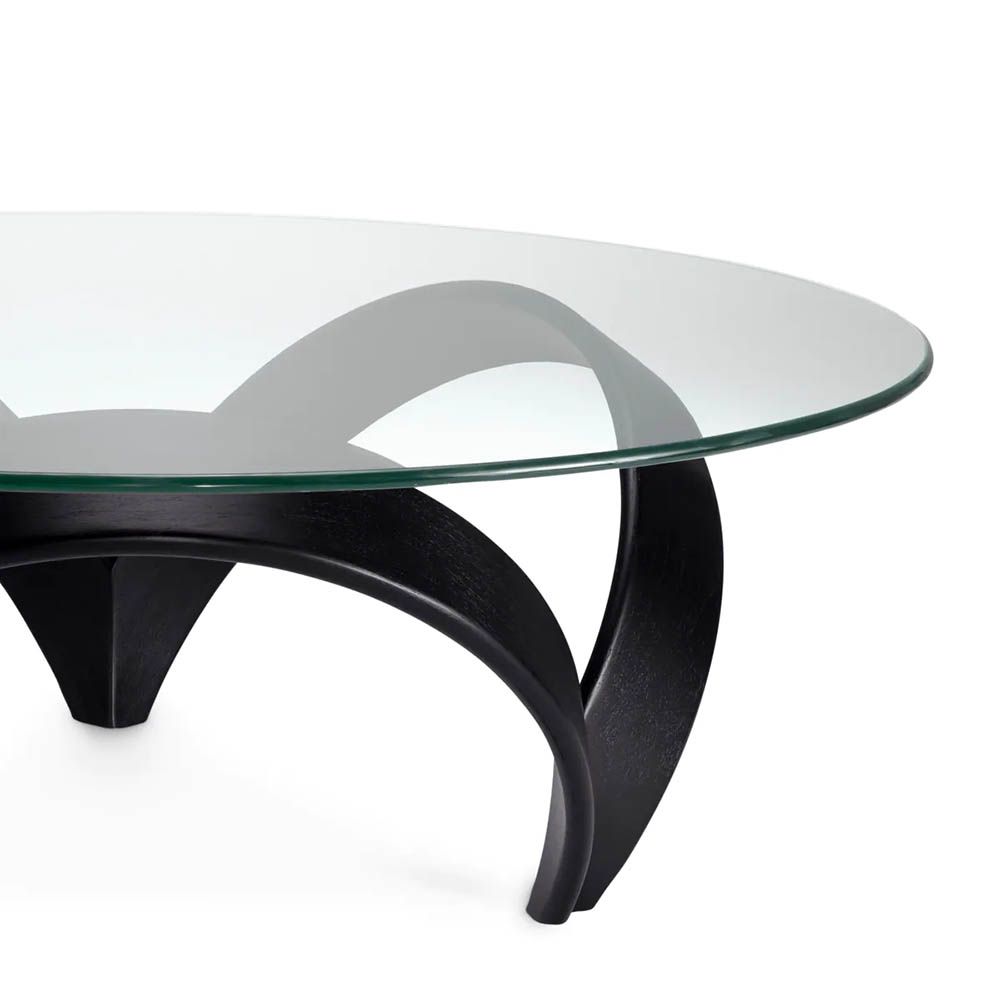 Curvaceous trio legged coffee table with round glass top