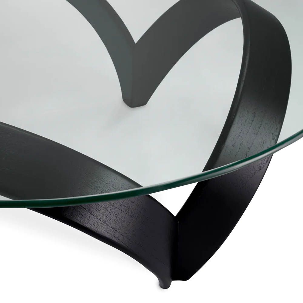Curvaceous trio legged coffee table with round glass top