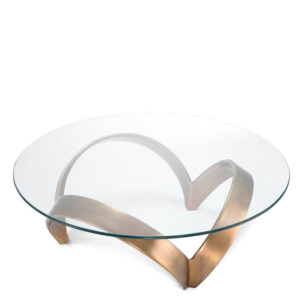 Curvaceous trio-legged coffee table in brass with round glass top