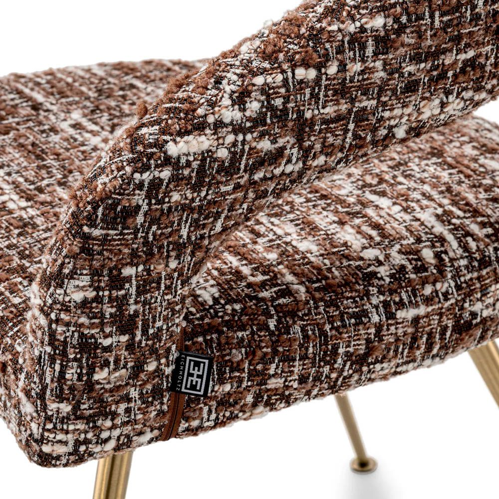 A stylish dining chair by Eichholtz with an open back and statement upholstery