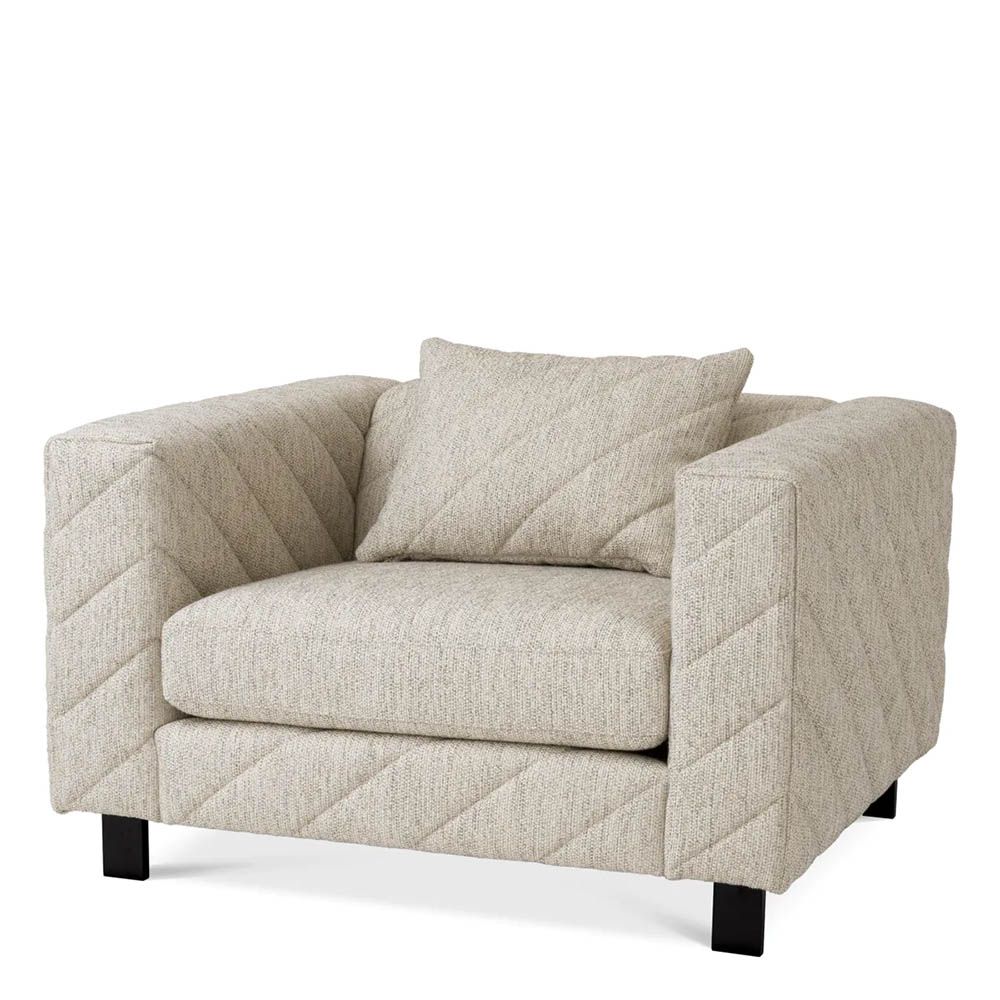 Grey upholstered modern armchair with chevron stitching detail