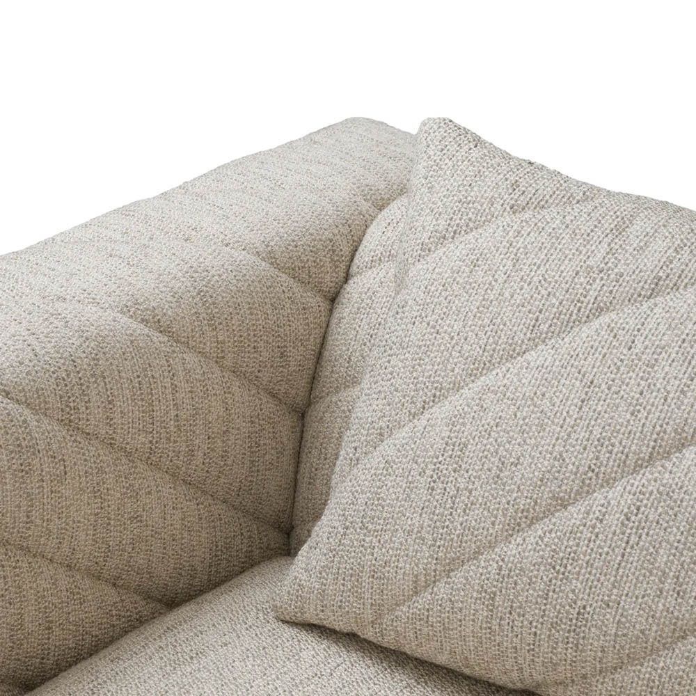 Grey upholstered modern armchair with chevron stitching detail