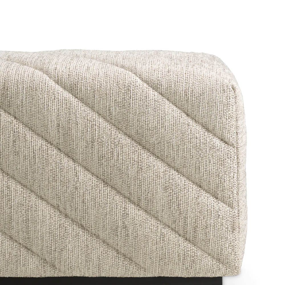 Grey upholstered modern sofa with chevron stitching detail