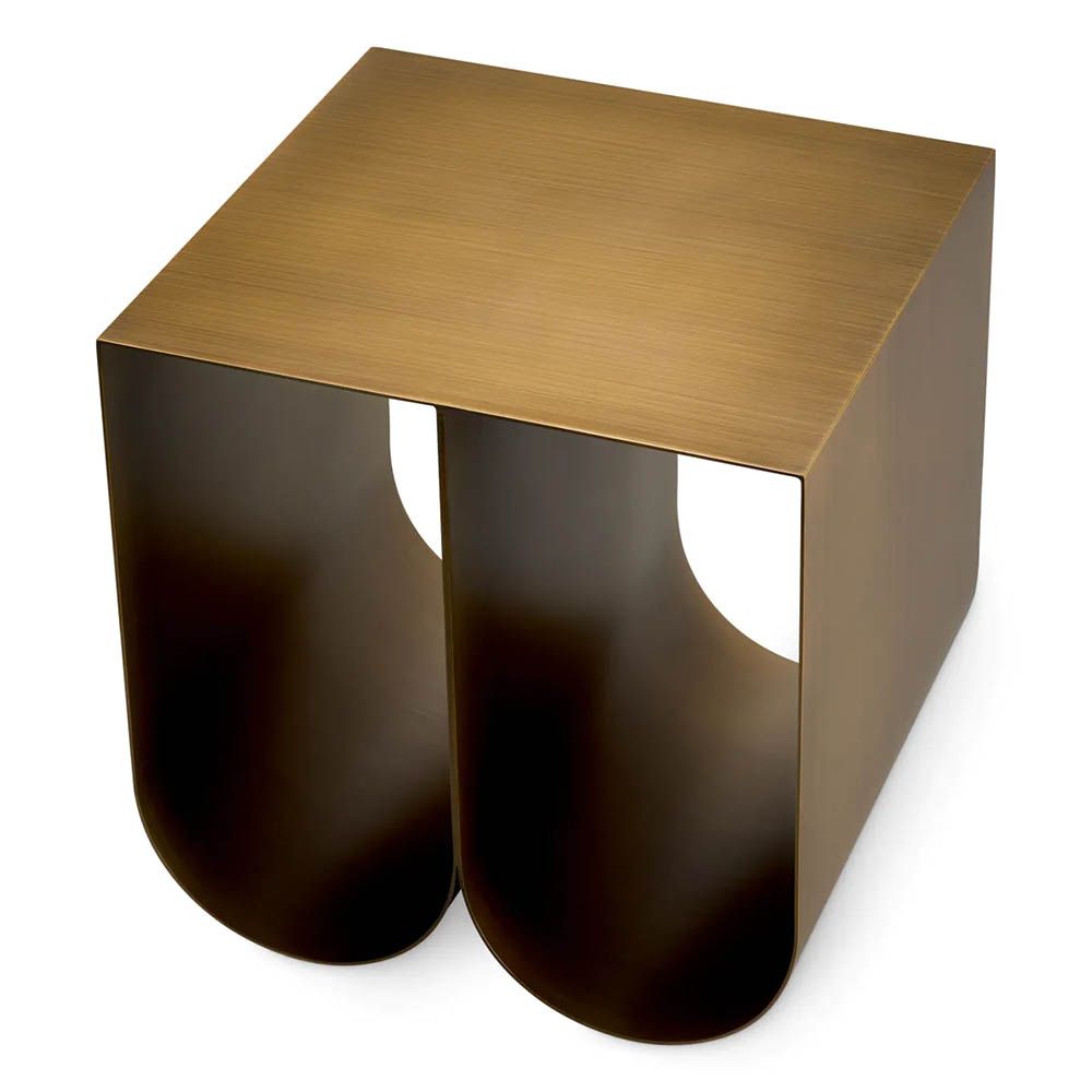 Modern side table with two curved legs finished in brushed brass