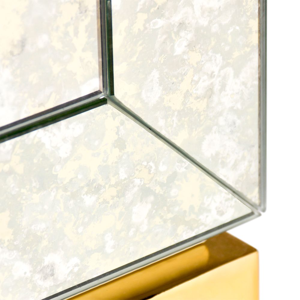 An elegant antiqued glass and polished brass maximalist bar