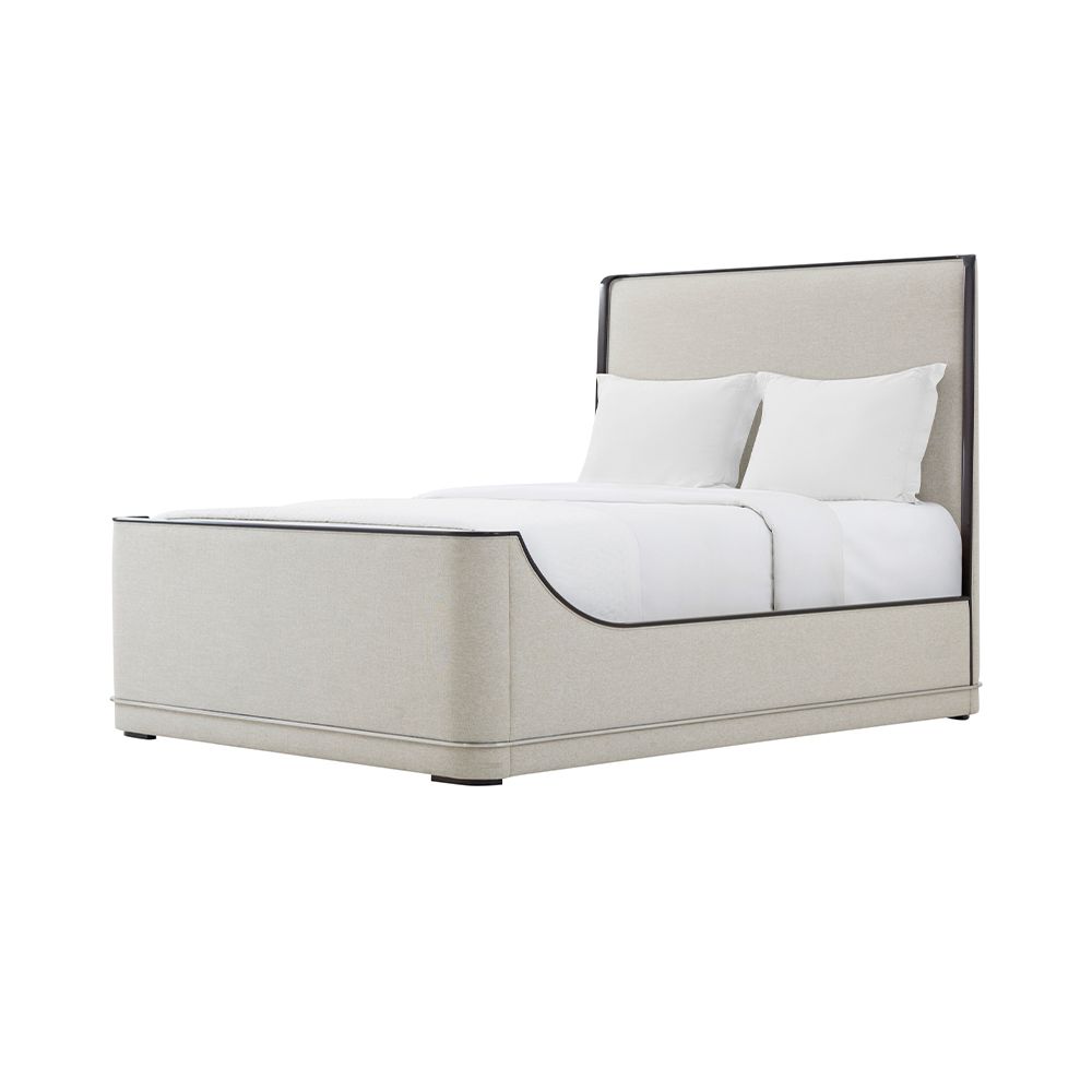 Grey upholstered bed with curved base and maple accents