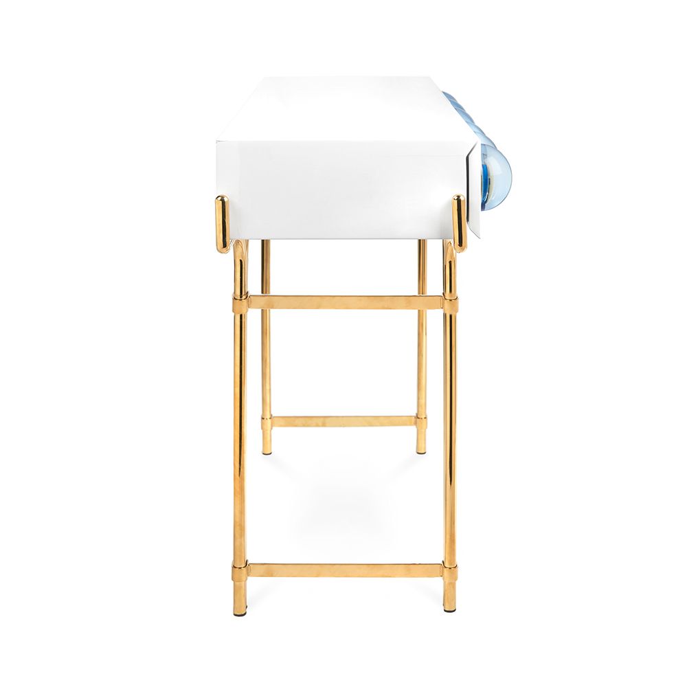 A futuristic white console table with blue acrylic cabochons and a polished brass base 