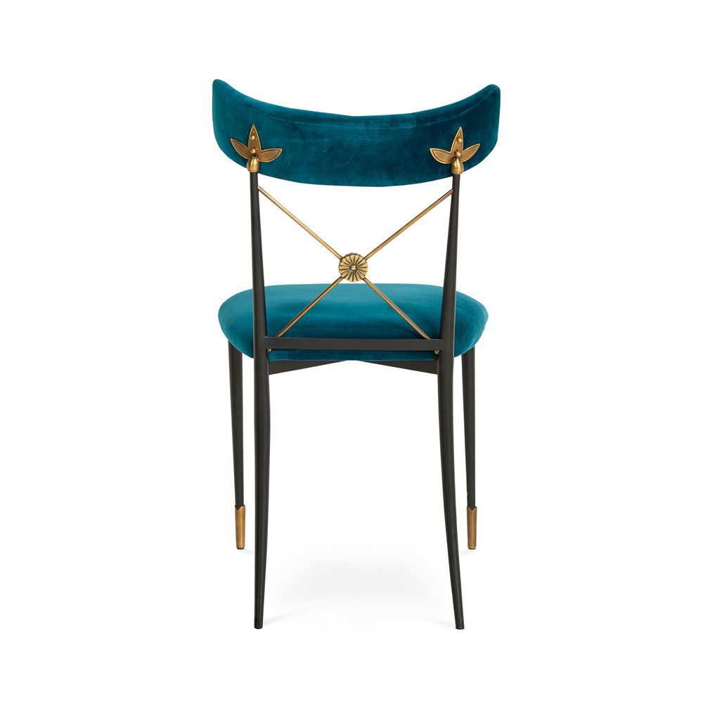 A luxurious vintage-style dining chair with polished brass accents and navy upholstery